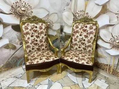 a pair of chairs in a room with flowers at birds House in Jerash
