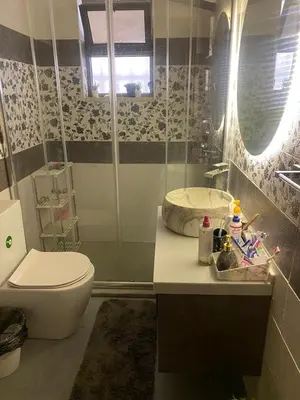 a bathroom with a toilet and a sink at Amman Apartment 123 in Amman