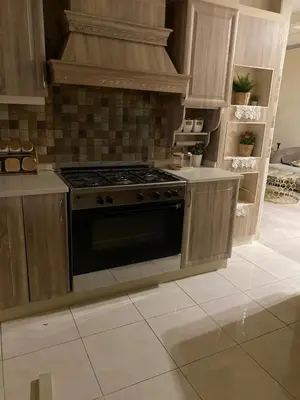 a kitchen with a stove top oven in a room at Amman Apartment 123 in Amman
