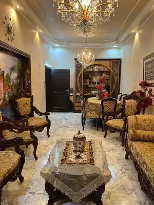 a living room filled with furniture and a chandelier at 909 apartment in Amman