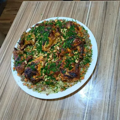 a white plate of food on a table at 909 apartment in Amman