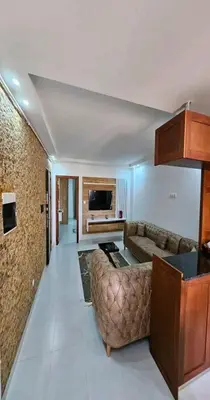 a living room with a couch and a television at 909 apartment in Amman