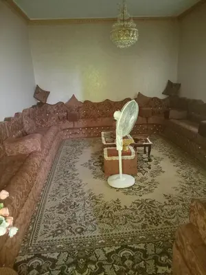 a living room with a couch and a table at 909 apartment in Amman