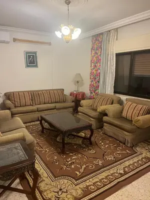 a living room with couches and a coffee table at University Castle in Amman