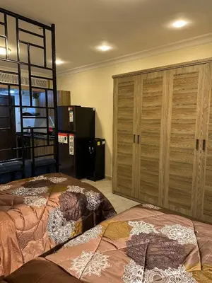 a bedroom with two beds and a large closet at gardens studio استوديو الجاردنز 401 in Amman