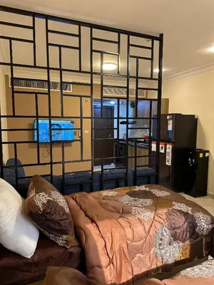 a large bed in a room with at gardens studio استوديو الجاردنز 401 in Amman