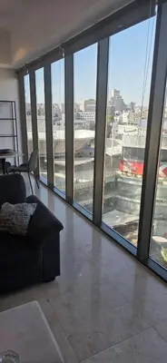 a living room with a view of an airport at One Bedroom Damac Tower 8th Floor Boulevard Abdali غرفة وصالة فاخرة - برج داماك العبدلي البوليفارد الطابق الثامن in Amman