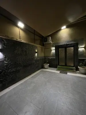 a room with a stone floor and a wall with plants at Firuza Farm Villa Vip in Al Rama