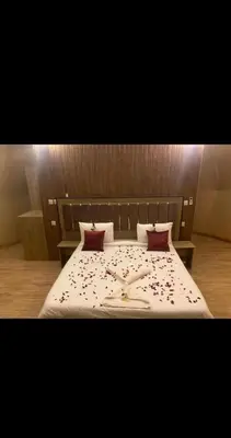 a bedroom with a large bed with red pillows at جمال رم in Aqaba