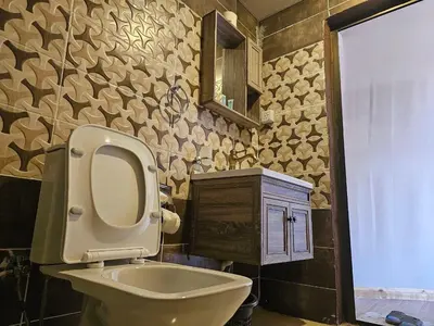 a bathroom with a toilet and a sink and a mirror at جمال رم in Aqaba