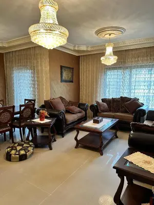 a living room with couches and tables and chandeliers at shafa badran شفا بدران ام الحجير in Amman