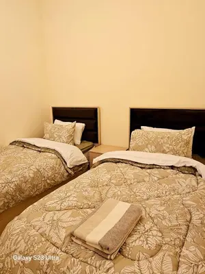 two beds sitting next to each other in a room at C33 Samarah Resort LOFT apartment in Sowayma