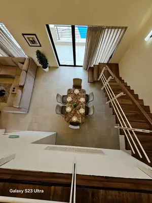 a living room with a spiral staircase in a house at C32 Samarah Resort LOFT apartment in Sowayma