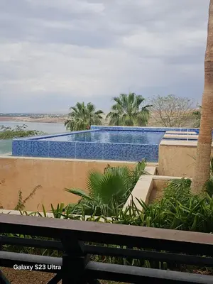 a view of a swimming pool from a balcony at C04 Samarah Resort One Bedroom apartment in Sowayma