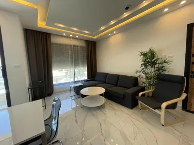 a living room with a couch and a table at Premium 1BR Furnished Apartment in Amman