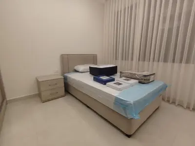 a bedroom with a bed with boxes on it at Newly Built apartment Deir Ghbar in Amman