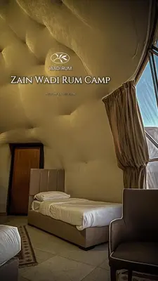 a bedroom with a bed and a window at Zain Wadi Rum Camp in Wadi Rum