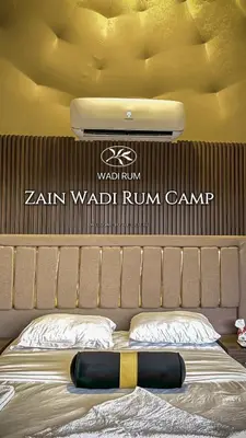 a bedroom with a bed with a sign above it at Zain Wadi Rum Camp in Wadi Rum