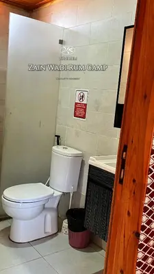 a bathroom with a toilet and a sink at Zain Wadi Rum Camp in Wadi Rum