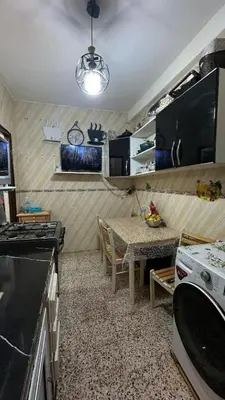 a kitchen with a table and a dining room at VOV House in At-Tafilah