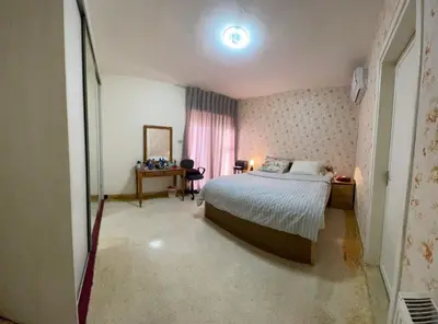 a bedroom with a bed and a table and a mirror at zainab house in Amman