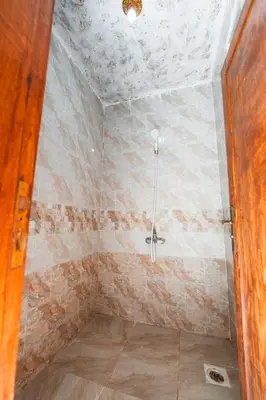 a bathroom with a shower in a room at Wadi Rum Sunrise Guesthouse in Wadi Rum