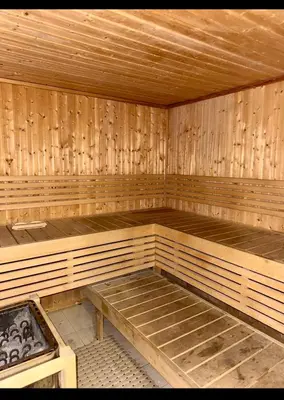 an empty wooden sauna with a bench in it at Amman damac tower عبدلي عمان دماك Abdali Boulevard in Amman