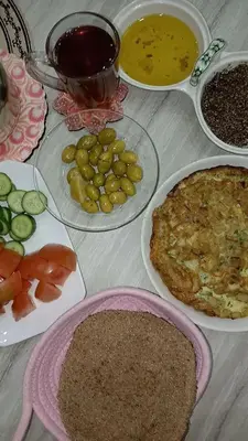 a table with plates of food on a table at Bonuk House in Kufayrāt Abū Khīnan