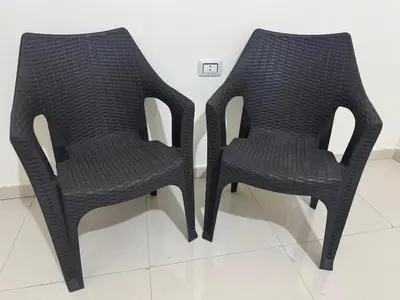 two black chairs sitting next to each other at Bonuk House in Kufayrāt Abū Khīnan