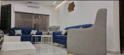 a living room with two blue couches and a couch at Cozy, Newly Furnished & Budget Friendly Apartment in Amman