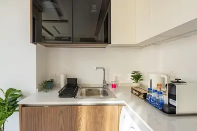 a kitchen with a sink and a microwave at Shamsi Apartments 008 in Amman