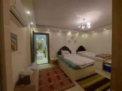 a room with two beds and a hallway with a mirror at نسيم الرمثاء in Ar Ramthā
