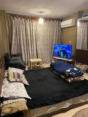 a bedroom with a large bed with a flat screen tv at نسيم الرمثاء in Ar Ramthā