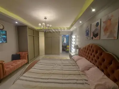 a bedroom with a large bed and a couch at نسيم الرمثاء in Ar Ramthā