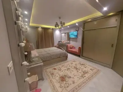 a bedroom with a bed and a living room at نسيم الرمثاء in Ar Ramthā