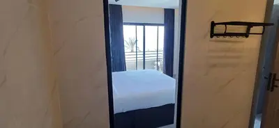 a mirror in a room with a bed and a window at LV Spring Water Resort in Mukāwir