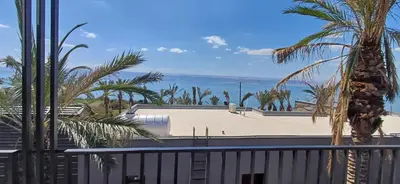 a view from the balcony of a house with palm trees at LV Spring Water Resort in Mukāwir