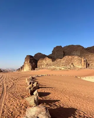 a sandy beach with rocks in the desert at Wadi rum Mahmoud tours in Wadi Rum