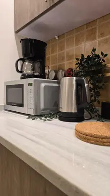 a kitchen counter with a microwave and a toaster at Modern One Bedroom with Steps from the Best Shops in Amman