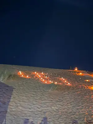 a beach at night with lights in the snow at Faraj wadi rum in Disah