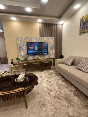 a living room with a couch and a flat screen tv at Sewar hostel in Petra