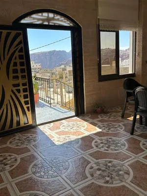 a room with a large glass door with a view at Sewar hostel in Petra