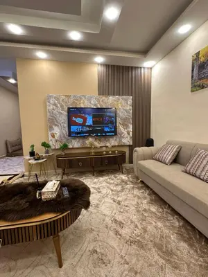 a living room with a couch and a flat screen tv at Sewar hostel in Petra