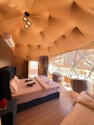 a large room with a bed and a large ceiling at Desert Sands Camp Wadi Rum in Wadi Rum