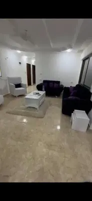 a large living room with couches and tables at Beautiful Apartment in irbid in Aydūn