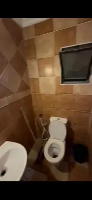 a bathroom with a toilet and a sink at Beautiful Apartment in irbid in Aydūn