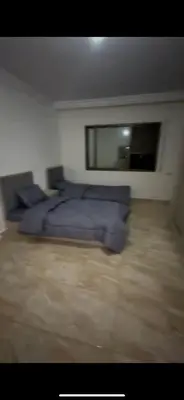a bedroom with a bed with blue pillows at Beautiful Apartment in irbid in Aydūn