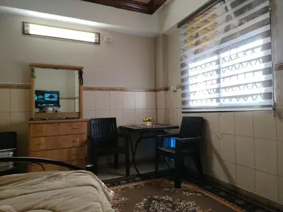 a room with a table and chairs and a mirror at بيت الحجر in Amman