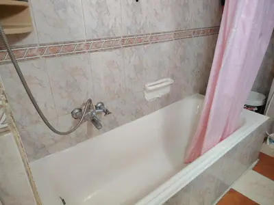 a bathroom with a bath tub with a pink shower curtain at بيت الحجر in Amman