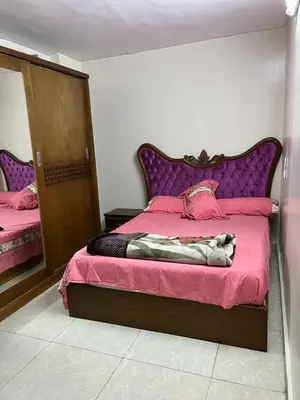 a bedroom with a large bed with a purple headboard at جبال الاردن in Amman